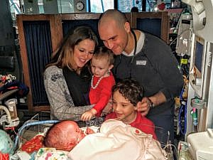 The Boykin Family gathers around baby Juliet while in the hospital